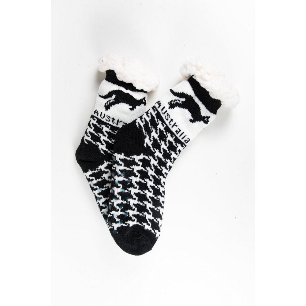 Cosy home socks for women with fluffy inner lining and non slip bottom in black kangaroo print, flat lay showing pattern