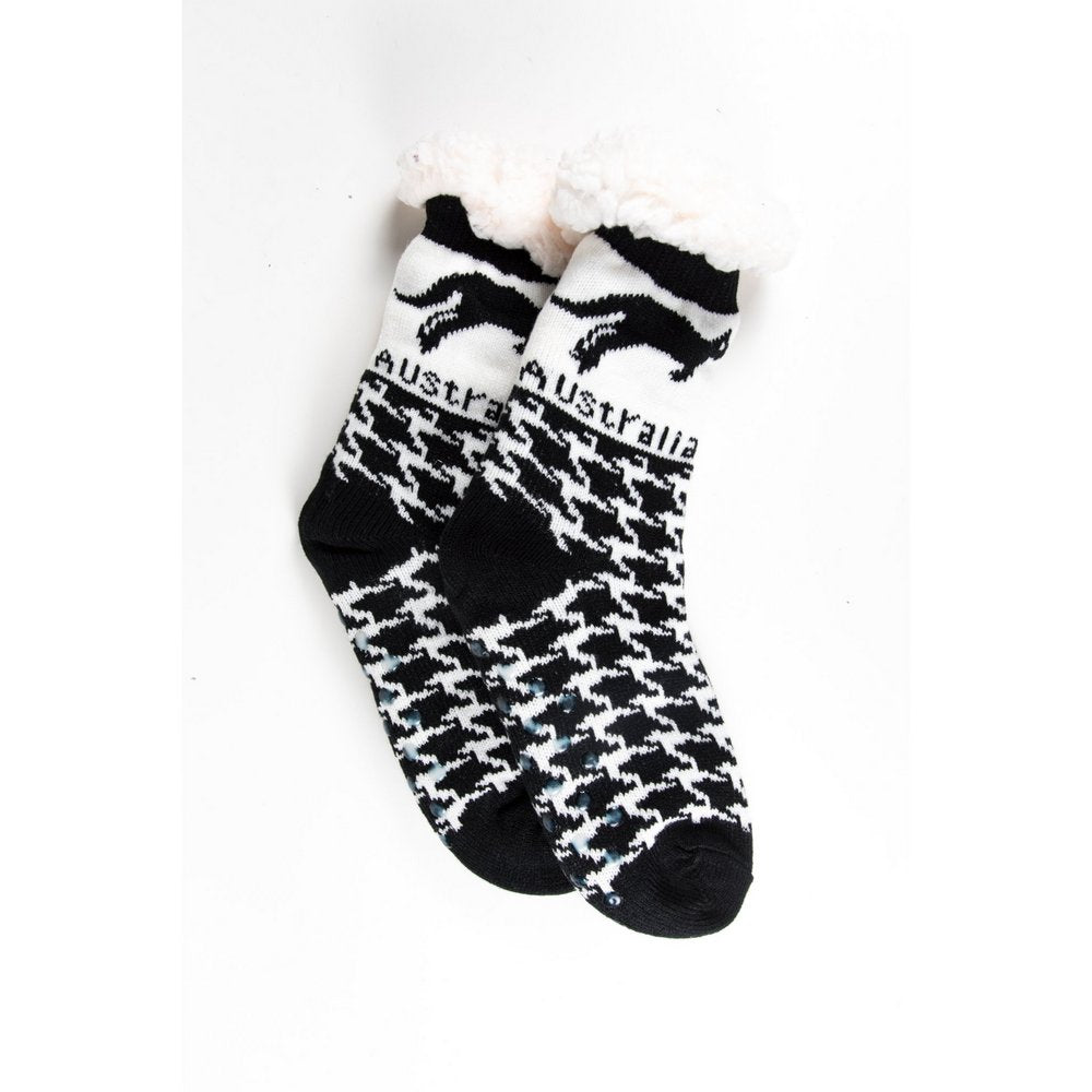 Cosy home socks for women with fluffy inner lining and non slip bottom in black kangaroo print, flat lay showing length