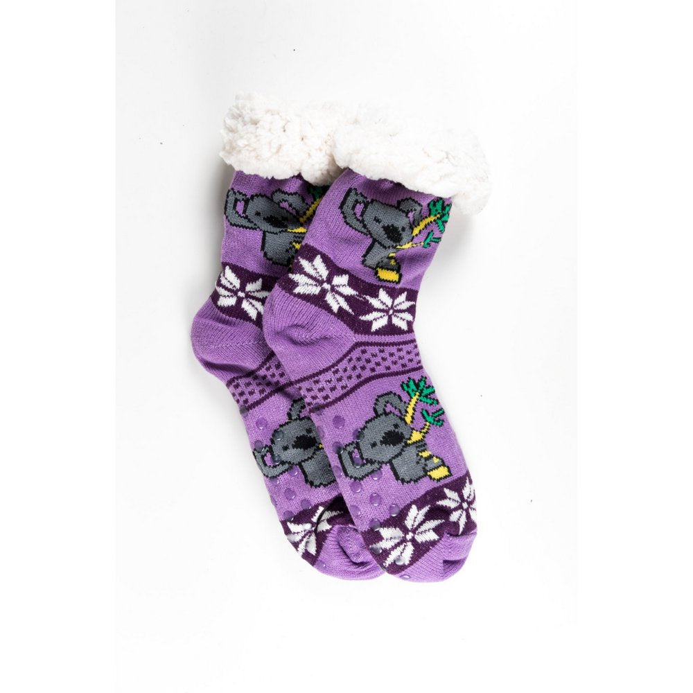 Cosy home socks for women with fluffy inner lining and non slip bottom in purple koala print, flat lay showing print