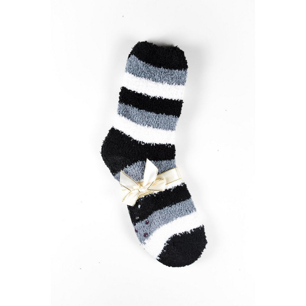 Cosy bed socks for women with non-slip bottoms in black grey stripes, flat lay showing gift packaging