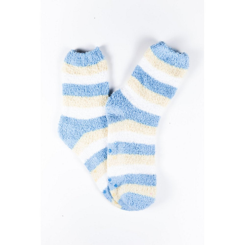 Cosy bed socks for women with non-slip bottoms in baby blue yellow stripes, flat lay showing pattern