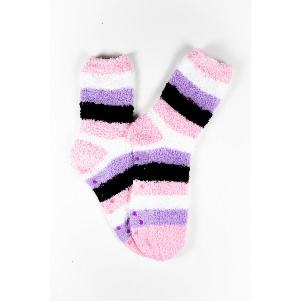 Cosy bed socks for women with non-slip bottoms in pink purple black stripes, flat lay showing pattern 