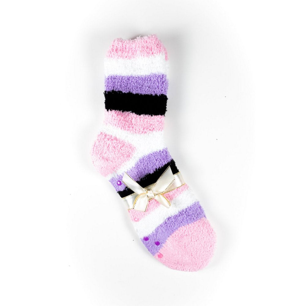 Cosy bed socks for women with non-slip bottoms in pink purple black stripes, flat lay showing gift packaging